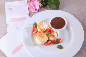 Cheesecakes with strawberries and jam. Healthy and nutritious breakfast. View from above. Jam and strawberries with cheesecakes.