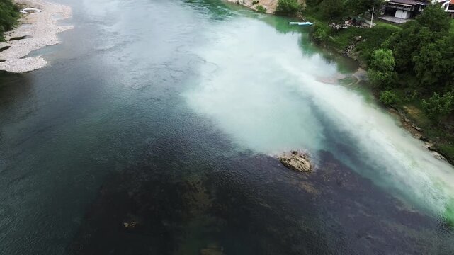 Famous Drina River house on a rock near Bajina Basta, Serbia, surrounded by water and forested mountains. Unique landmark and popular tourist attraction. Vertical aerial 4k footage