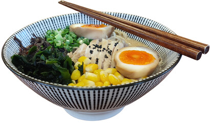 Ramen or Japanese noodles in a bowl with chopsticks, garnished with egg halves, chopsticks. corn kernels, seaweed and black sesame seeds  