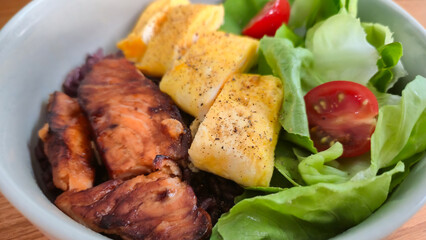 Grilled chicken with pineapple and fresh salad in a bowl healthy meal