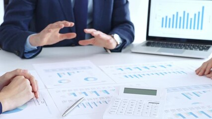 Analyzing financial data and business growth strategies during a corporate meeting, presenting reports and discussing investment plans in an office environment - Powered by Adobe