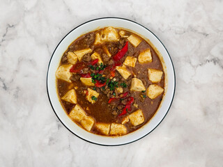 Mapo Tofu – Traditional Sichuan cuisine made with soft tofu and minced beef, infused with spicy chili oil and numbing Sichuan peppercorns.
