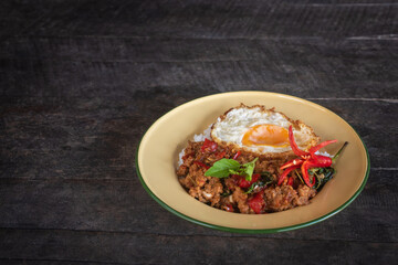 Stir-fried pork with basil and fried egg served in a traditional dish – Authentic Thai street food. Still image