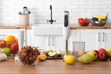 Modern blender and fresh fruits on table in kitchen