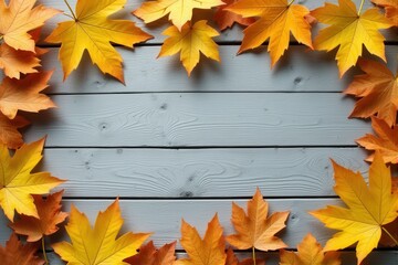 Autumn leaves on a white wooden background with copy space.
