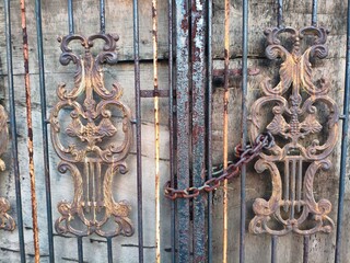Antique Wrought Iron Gate with Decorative Scrolls and Chain