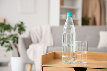 Plastic bottle of water on table in room, closeup