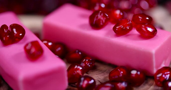 red peeled pomegranate with large juicy grains and sweet curd cheese in pink glaze, sweet red pomegranate seeds and curd sweet products