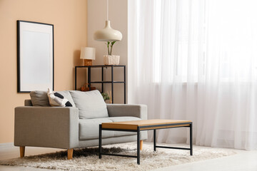 Interior of living room with sofa and table near window