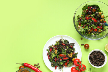 Plate with healthy quinoa salad and ingredients on green background