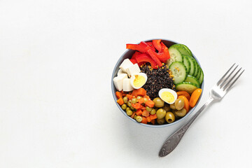 Bowl with healthy quinoa salad isolated on white background