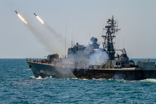 A Navy battleship makes missile launch during fighting with enemy aircraft. War ship shoot with gun.	