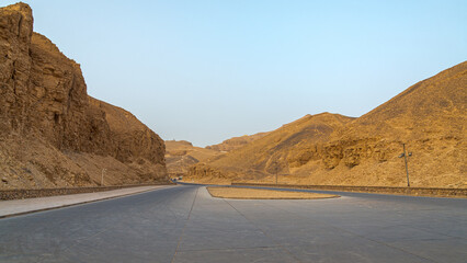 The road leading to the famous Valley of the Kings, with the Pharaoh tombs, Luxor, Egypt. Blue sky on the background.