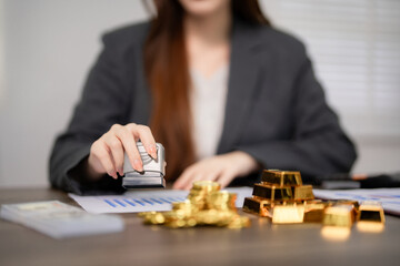 Financial professional stamps document managing gold investment assets for secure business transactions and wealth management at office