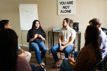Woman sharing experience in group therapy session