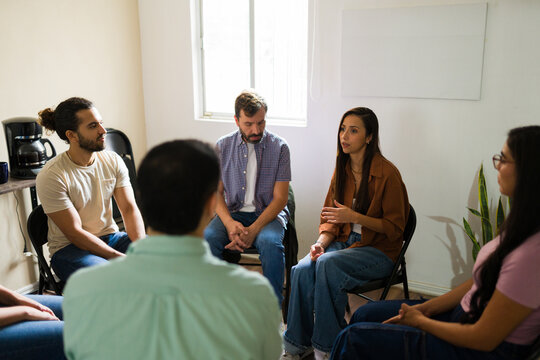 Women and men participating in support group meeting