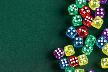 Different game dices on green background, closeup