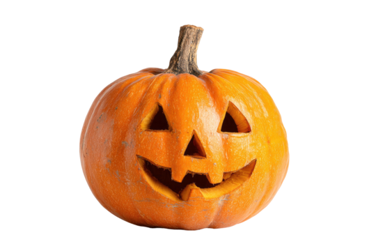 Bright orange carved fruit with triangular eyes, nose, and a toothy grin, dark background