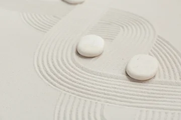 Fotobehang Zen Stenen Spa stones on light sand as background, closeup. Zen concept  © Pixel-Shot