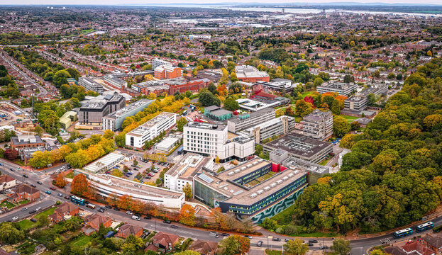 Drone photo of Southampton University buildings integrated into the suburban cityscape, surrounded by autumn trees and residential areas