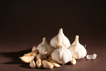 Many fresh garlics on brown background