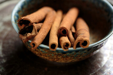 Aromatic cinnamon sticks in a handcrafted bowl