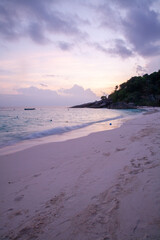 Serene Beach at Dusk with Gentle Waves and Footprints
