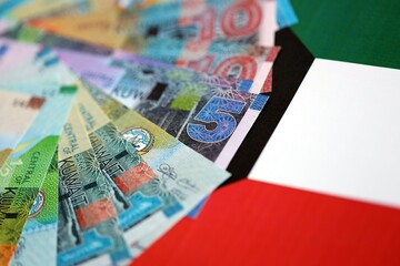 Kuwaiti dinar currency money bills lies on flag close up. The concept of business and investment