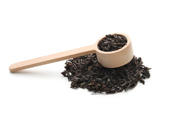 Wooden scoop with dry black tea leaves on white background