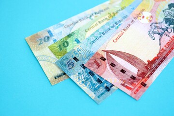 Bahraini dinar money bills in big amount on blue close up. Finance and banking concept