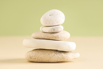 Stack of pebbles on color background. Zen concept