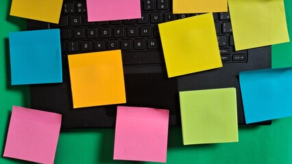 Colorful Sticky Notes on a Laptop for Organization and Reminders