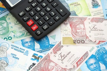 Nigerian naira currency money bills and calculator close up. The concept of taxation and money count