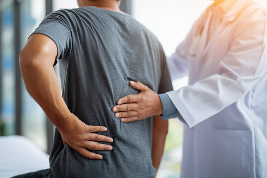 Therapist doctor treat perform pain young man in hospital.