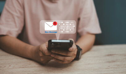 Close-up of hands holding smartphone with new message notification email on screen. Concept of digital communication, social media, online chatting and mobile technology connection