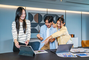  Vibrant business team consisting of diverse individuals joyfully raises their fists in celebration of a significant achievement, Celebrating success in a business team with joyful expressions