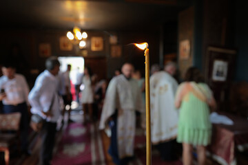 Shallow depth of field (selective focus) details with a candle inside an orthodox church during a...
