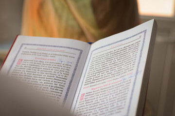 Shallow depth of field (selective focus) details with an orthodox priest in church during a baptism