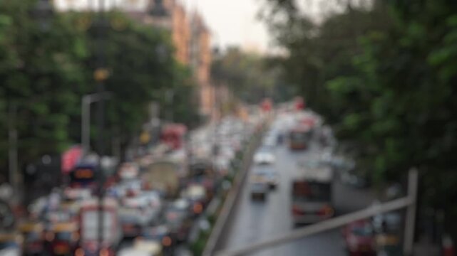 Bokeh view of road traffic near Chhatrapati Shivaji Maharaj Terminus (CSMT railway station) Mumbai, India. Blurred background footage.