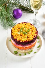 Christmas layered vegetable salad with herring and boiled vegeta