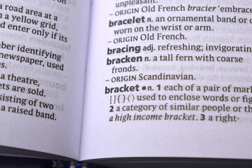 Obraz premium English Definition Dictionary Page Close Up Of Printed Word Of -Bracket