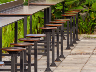Modern Outdoor High Table and Stools with Lush Green Foliage