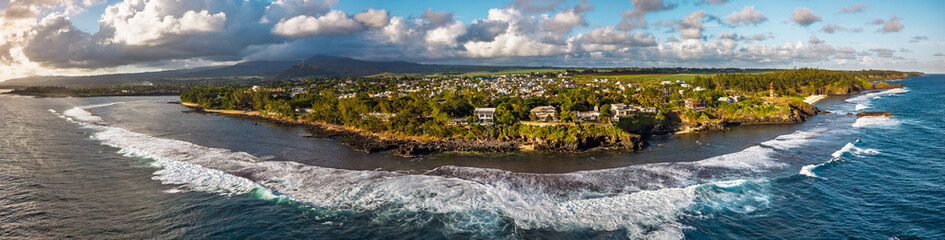 Gris Gris Mauritius aerial view with breaking waves over coral reef black rock headlands lighthouse and green shoreline © ronedya