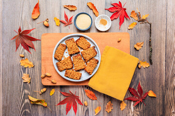 plate of parkin ginger cake in a flat lay with autumn leaves