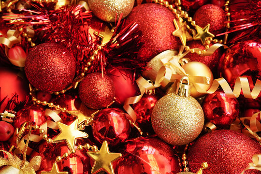 Golden and red balls, stars and berries background; festive Christmas and New Year celebration card, selective focus, shallow DOF