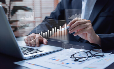 Big data analytics concept with businessman working on laptop, analyzing financial charts,...