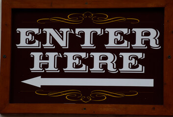 Enter here sign at store area.
