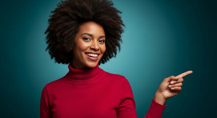 Smiling woman with afro hairstyle wearing red sweater, pointing finger to the right, suggesting attention or direction, ideal for guidance or focus concepts