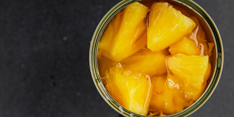 Pineapple canned chunks sweet fruit dessert tasty snack fresh delicious gourmet food background on the table rustic top view copy space keto and paleo diet vegetarian and vegan food