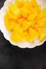 Pineapple canned chunks sweet fruit dessert tasty snack fresh delicious gourmet food background on the table rustic top view copy space keto and paleo diet vegetarian and vegan food